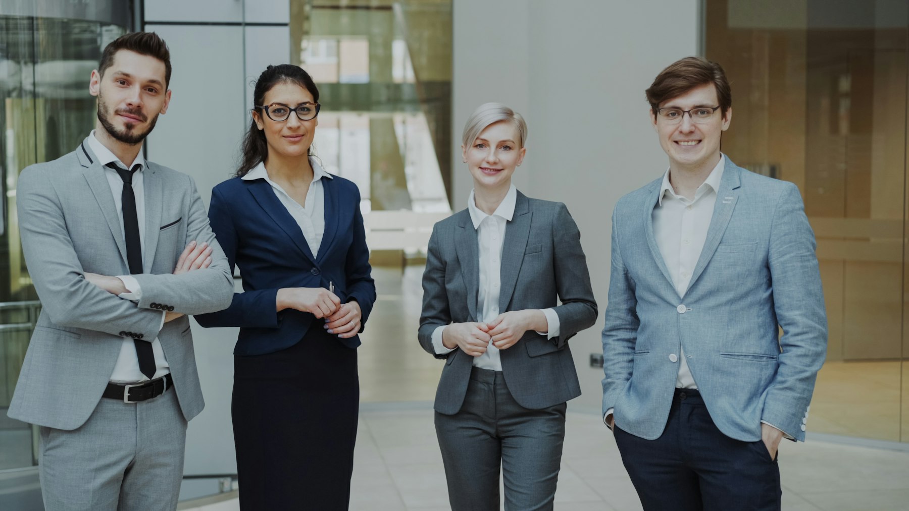 Colleagues standing together in an office lobby.